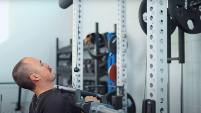 Coop using REP Fitness Cambered Swiss Bar to do lat pulldowns