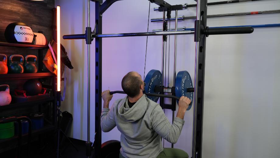 Coop does lat pulldowns on the RitFit Smith Machine.