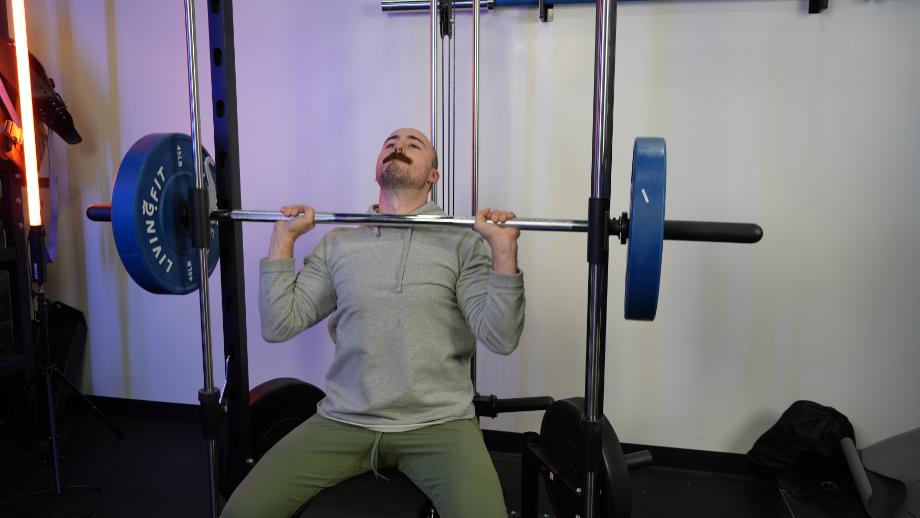 Coop doing an overhead press on the RitFit Smith Machine.