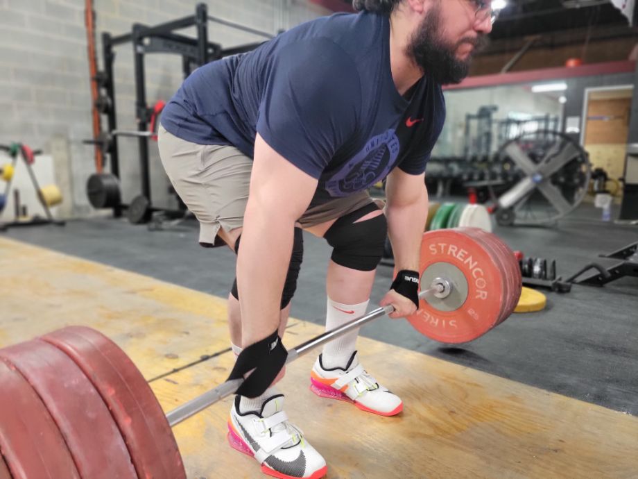 Man performing a deadlift with the Rogue Figure 8 Straps