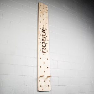 Rogue peg board on a white brick wall