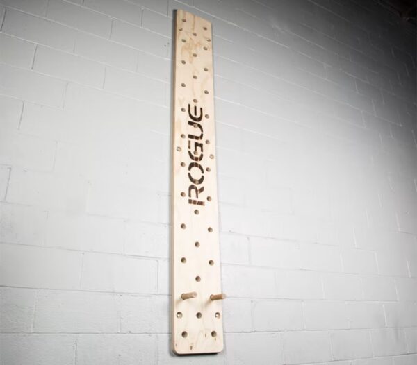 Rogue peg board on a white brick wall