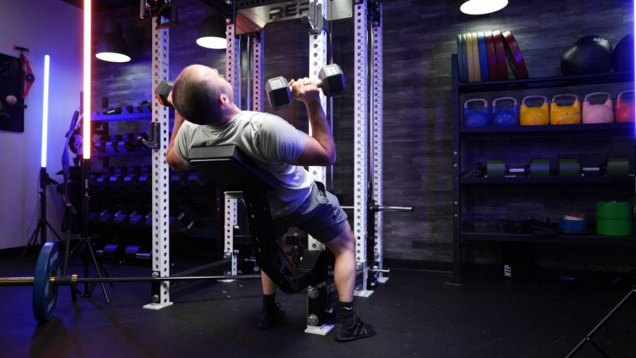 Man performing an incline press on the Rogue Pritchett Pad