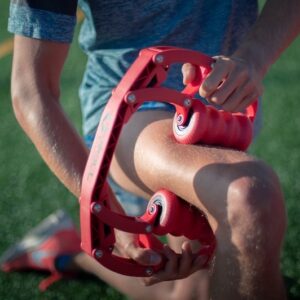 Image of someone using the Roll Recovery R8 in red on their leg