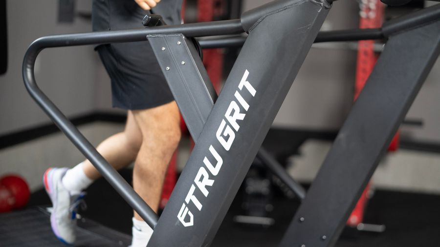 Coop running on the Tru Grit Grit Runner, closeup of the handlebars and frame