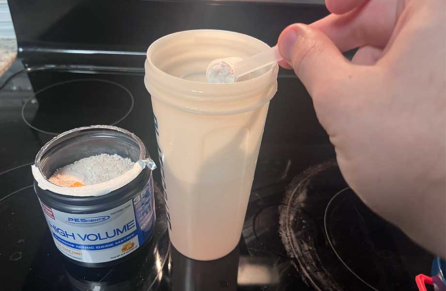 Sccoping a serving of PEScience High Volume Pre-Workout.