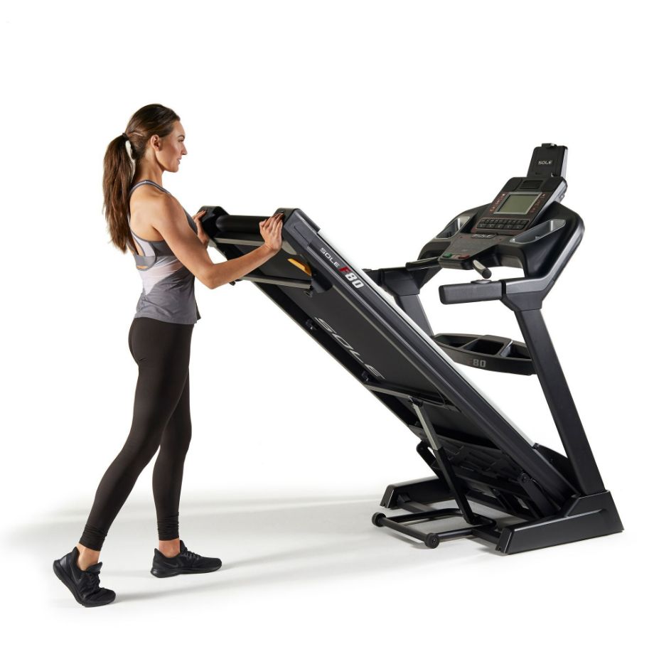 sole fitness f80 treadmill product photo woman folding machine