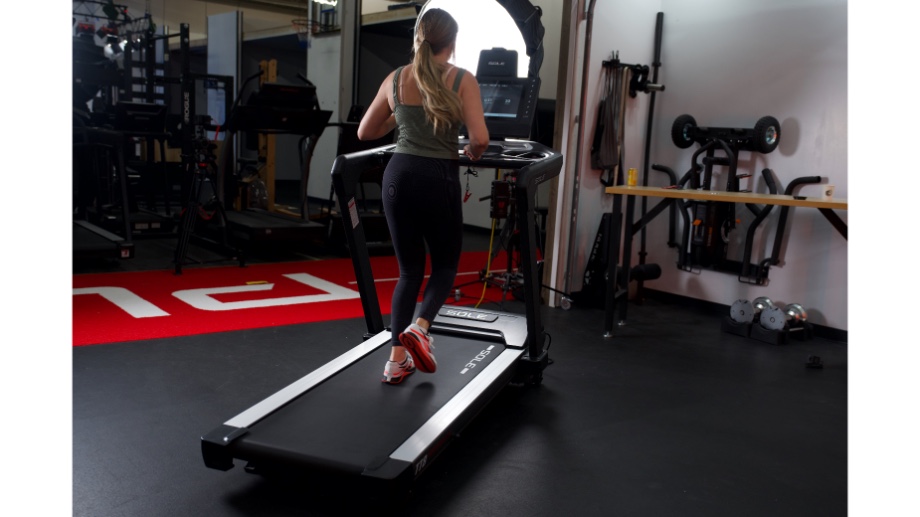 back view of woman running on sole fitness t88 treadmill