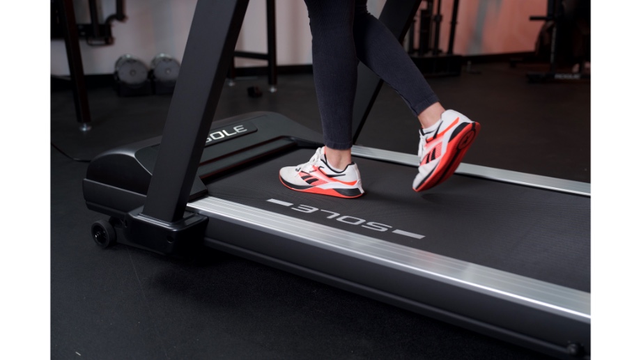 woman's feet running on sole fitness tt8 treadmill
