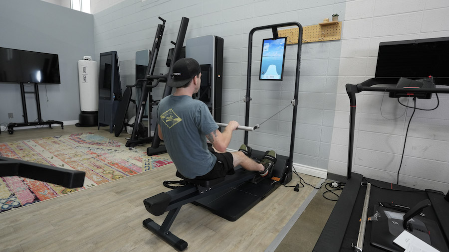 An image of a man rowing on Speediance