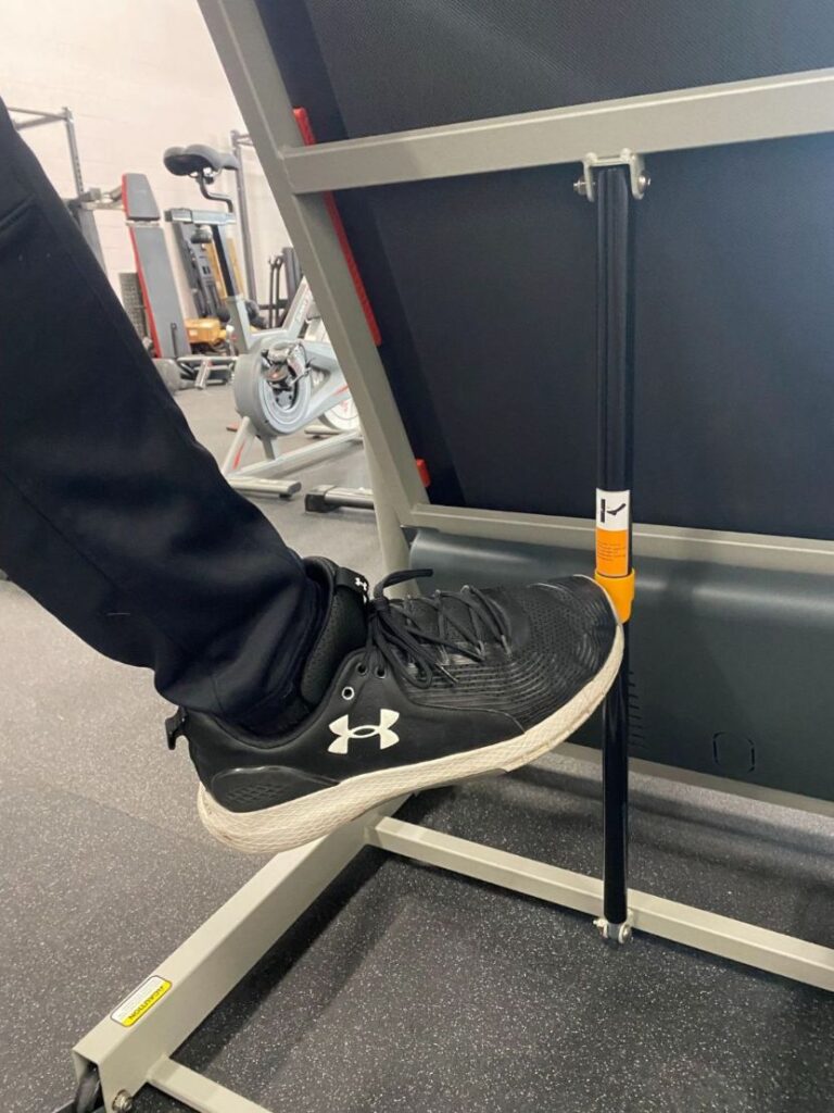 Anthony using the soft drop folding mechanism of the Sunny Health and Fitness Treadmill