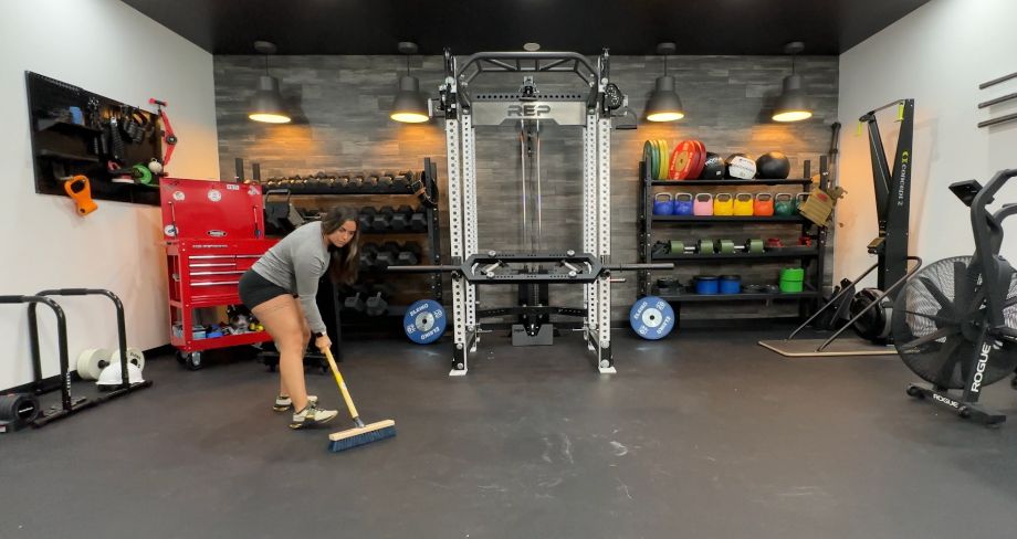 woman sweeping rubber flooring