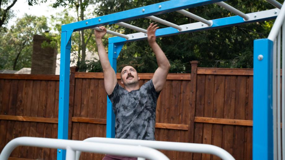 Coop "working out" on the SwingSesh monkey bars