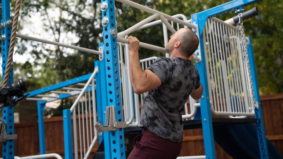 Coop does pull-ups on the SwingSesh SuperSesh