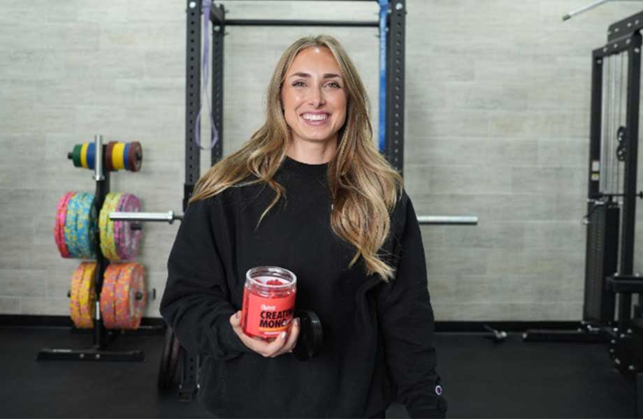 Woman holding a container of Swoly Creatine Gummies