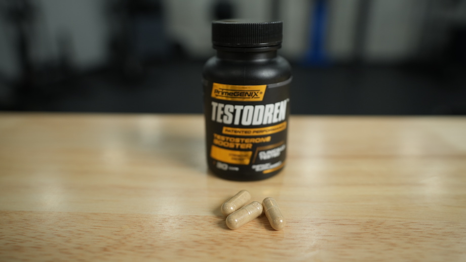 A bottle of the Testodren supplement is shown next to some capsules.