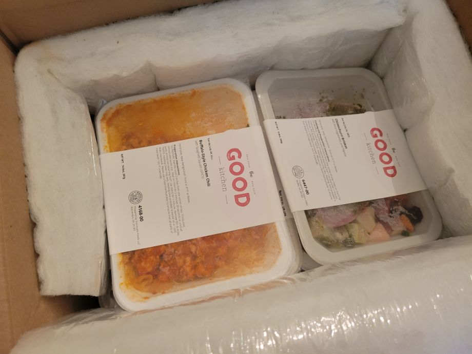 Looking down into a box full of stuff from The Good Kitchen Meal Delivery Service.