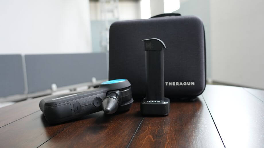 Thergun Pro with case and stand.