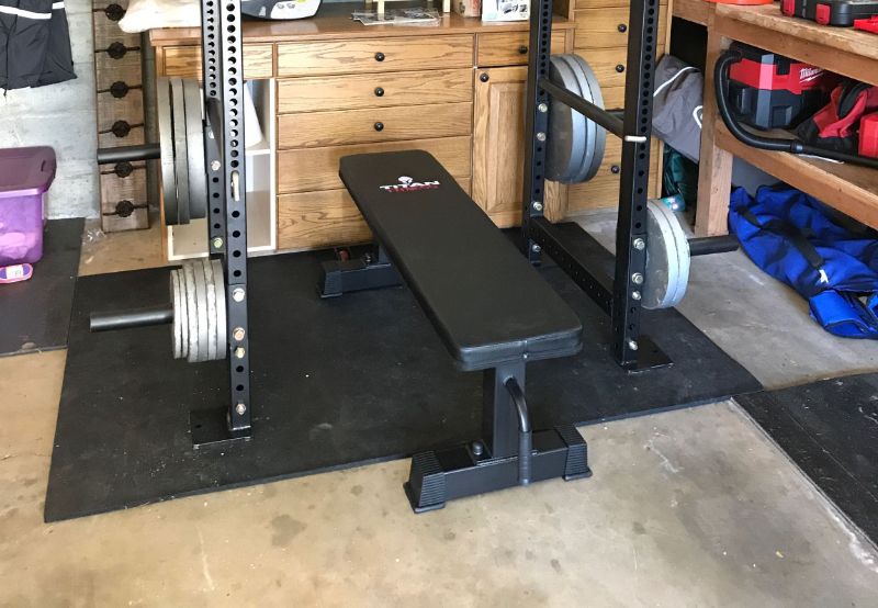 The Titan Fitness Weight Bench in a home garage gym