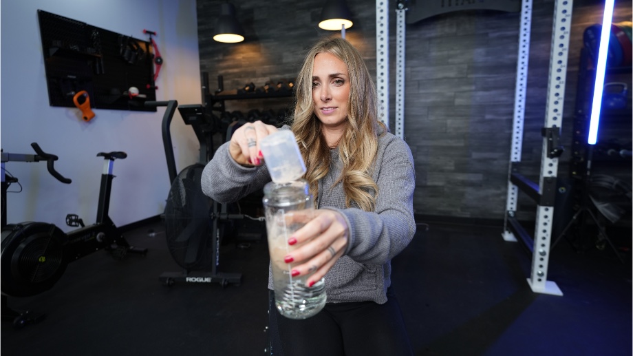Our tester mixing a glass of Transparent Labs 100% Grass-Fed Whey Protein Isolate.