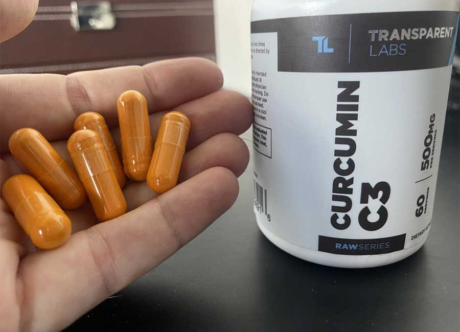 Hand holding Transparent Labs curcumin supplements