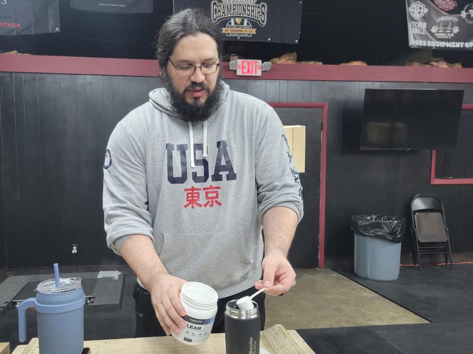 Caine Wilkes is shown mixing a batch of Transparent Labs Pre-Workout.