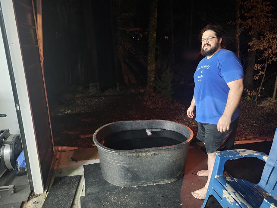 Man stands next to Tuff Stuff Stock Tank