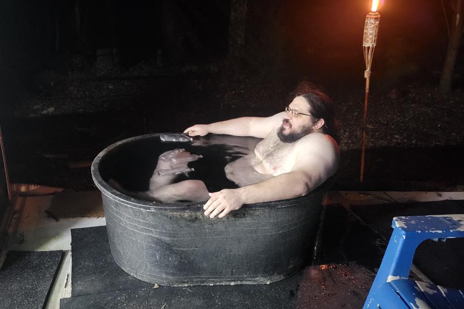 Man mostly submerged in Tuff Stuff Stock Tank full of ice water