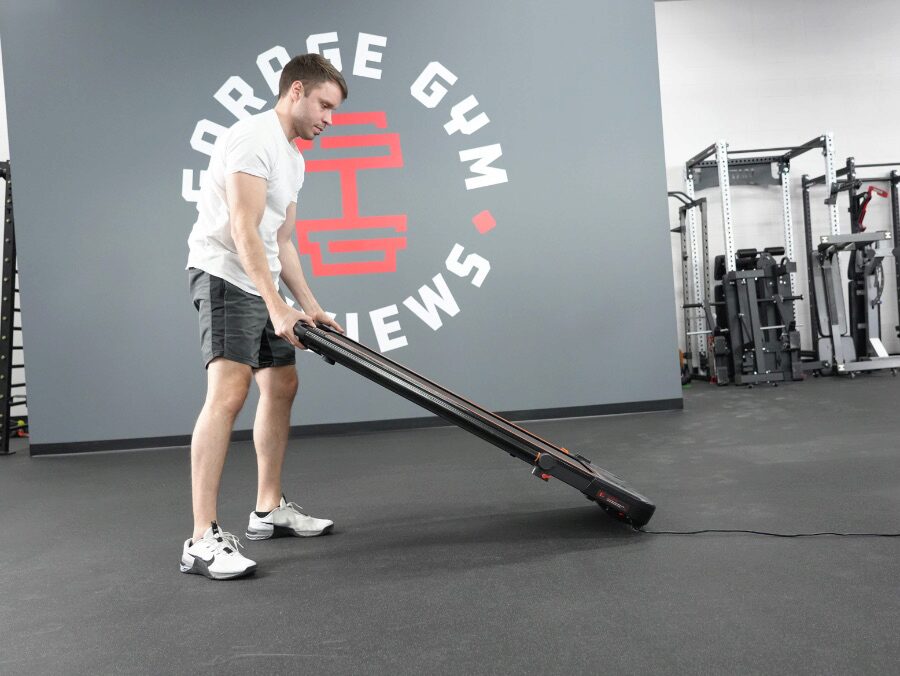 The UREVO treadmill being moved by Nathan.