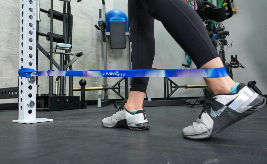 A person using a Living.Fit resistance band for exercises