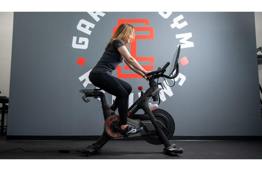 women using the peloton bike