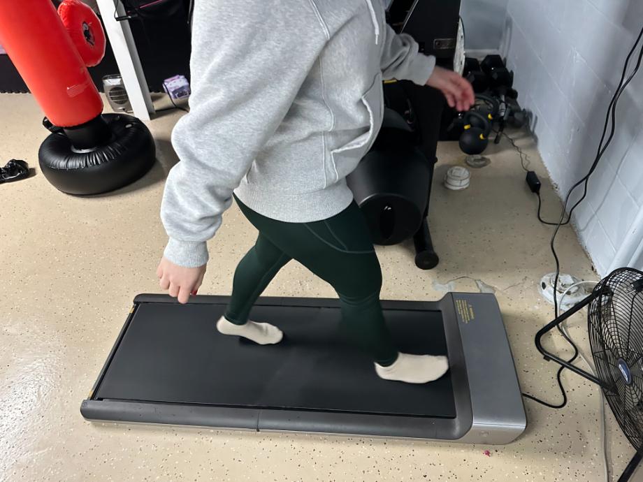 A person walks on a WalkingPad foldable treadmill