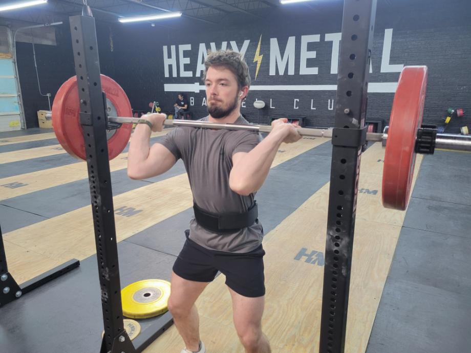 Man preparing to do a front squat with the Warm Body Cold Mind Nylon Weightlifting Belt