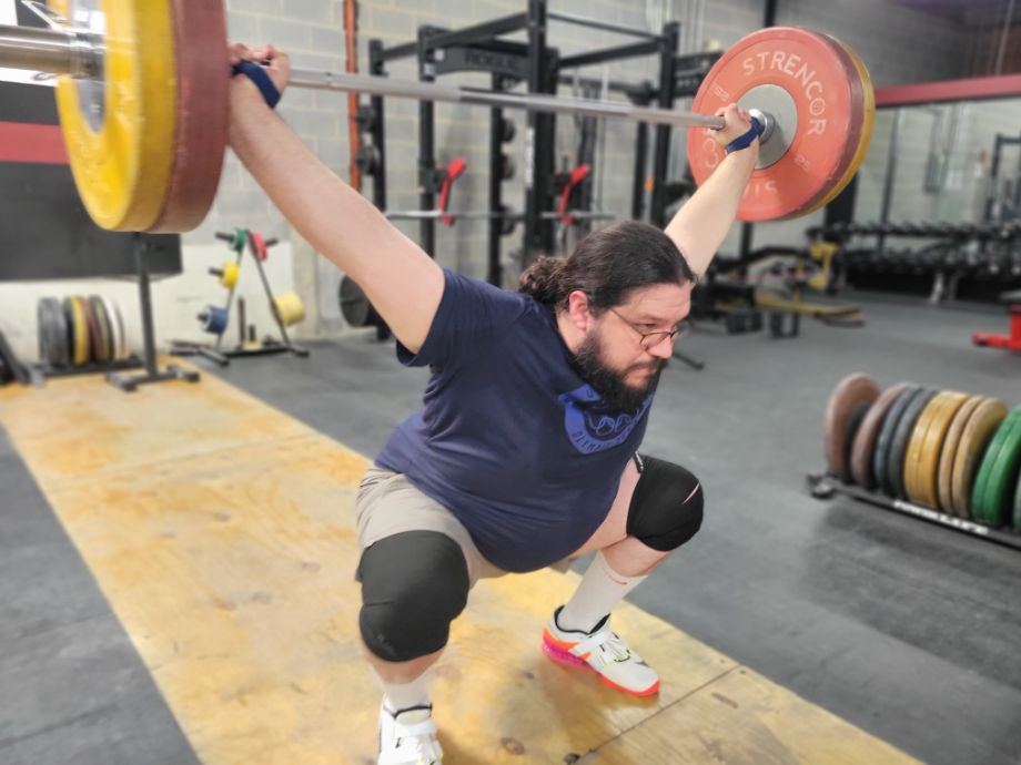 Man performing a snatch with the Weightlifting House Elite Straps