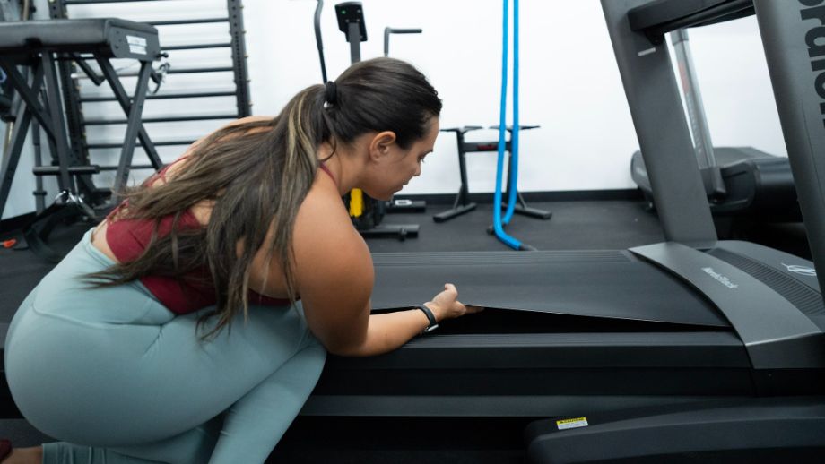 woman adjusting nordictrack treadmill belt