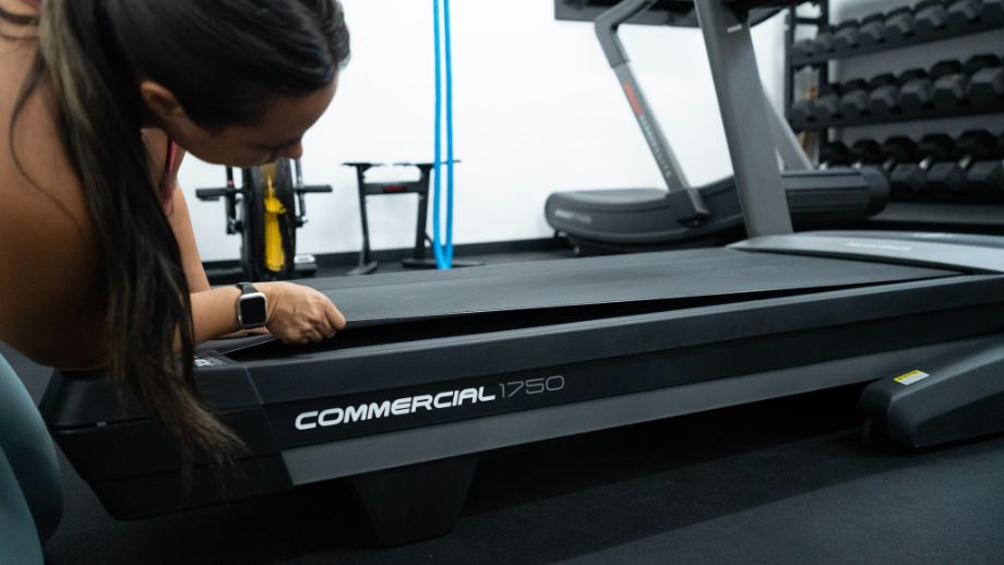 woman checking nordictrack treadmill belt