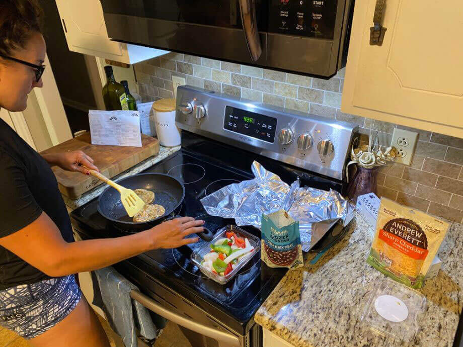Woman Cooking Hungryroot Chicken Burrito Bowl