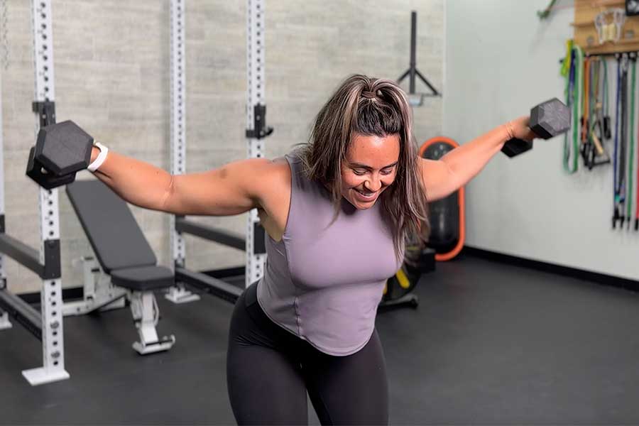 Woman doing a reverse dumbbell fly