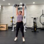 woman doing a dumbbell shoulder workout