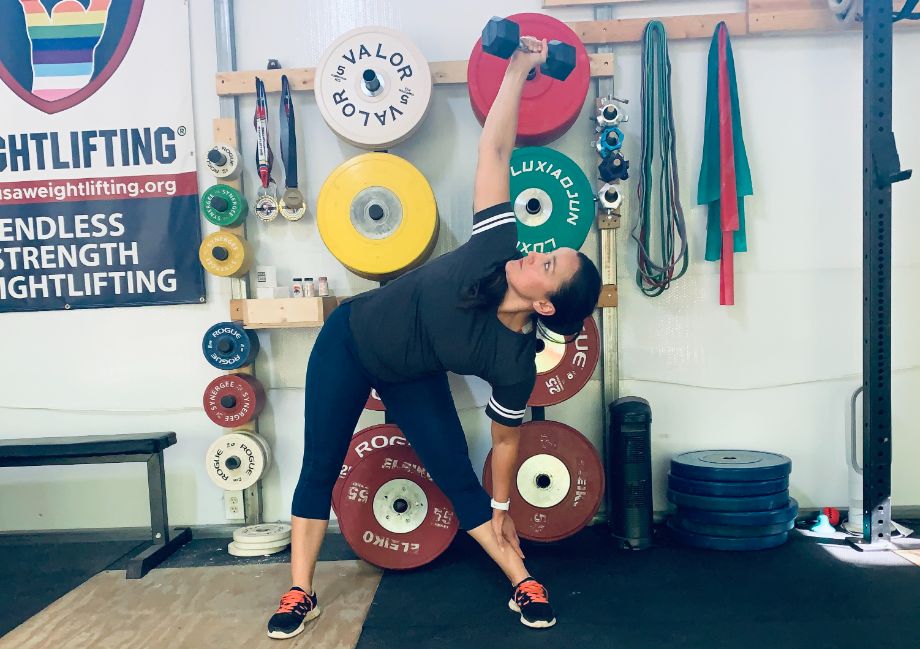 Woman doing a dumbbell windmill