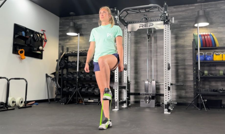 Woman doing a banded march for hip flexor exercise