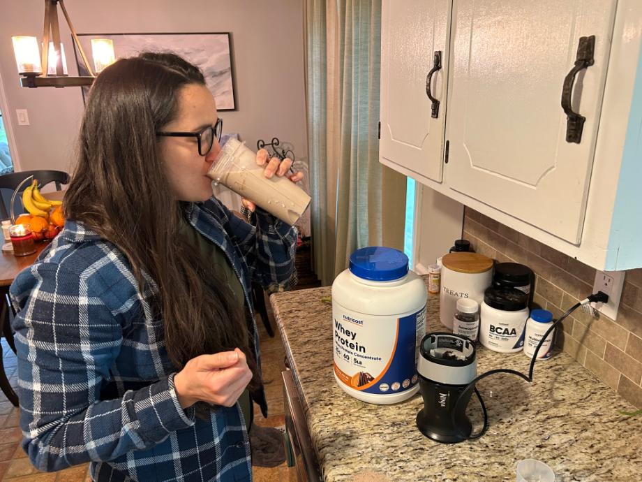 woman drinking nutricost whey protein