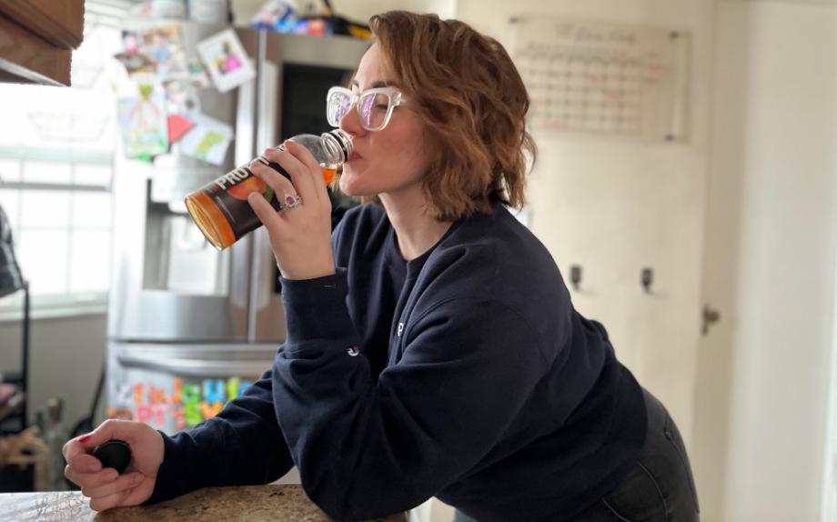 An image of a woman drinking protein2o