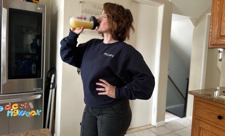 A woman is shown drinking a shake of SEEQ Clear Whey Protein Isolate