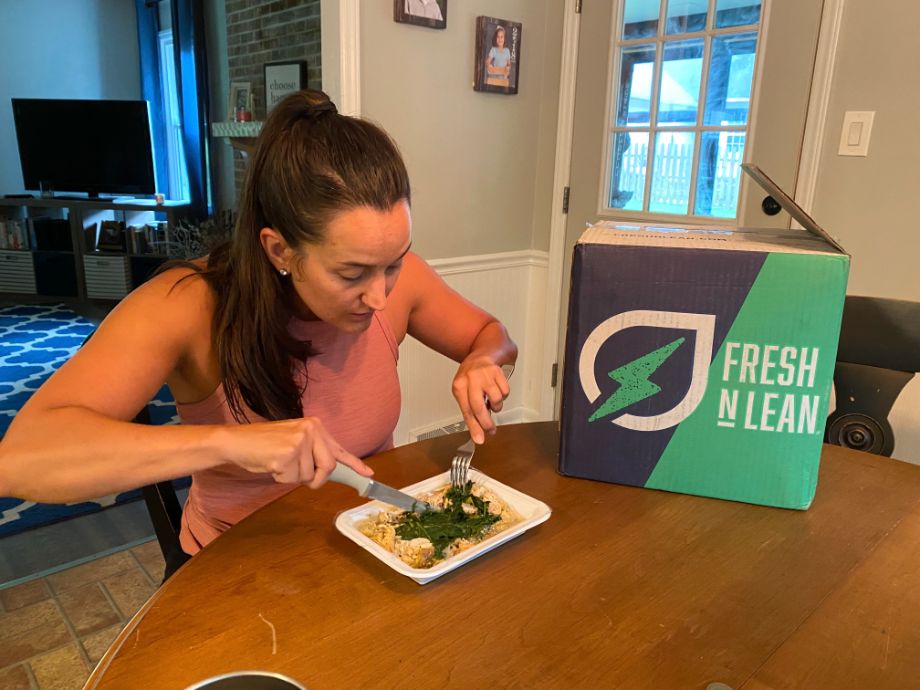 Woman eating a meal from Fresh N' Lean
