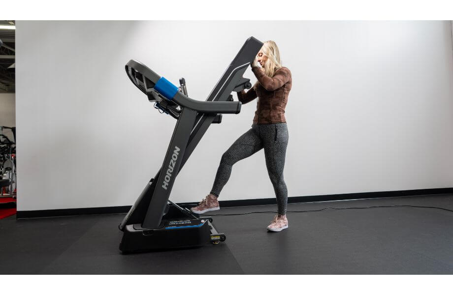 woman folding horizon 7.0 treadmill