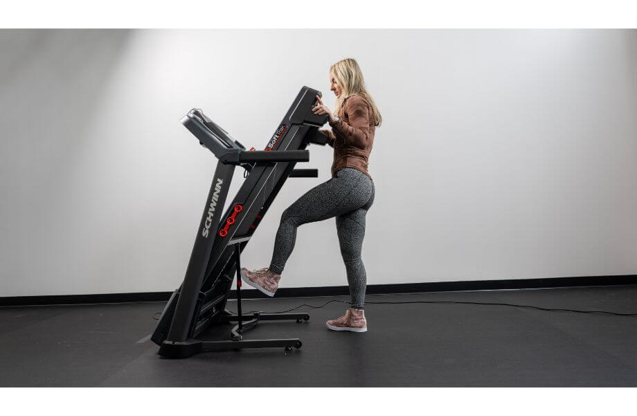 woman folding schwinn 810 treadmill