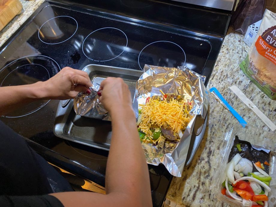 Woman making chicken burrito bowls from Hungryroot