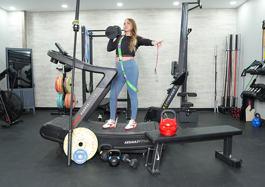 woman-on-treadmill-holding-gym-equipment