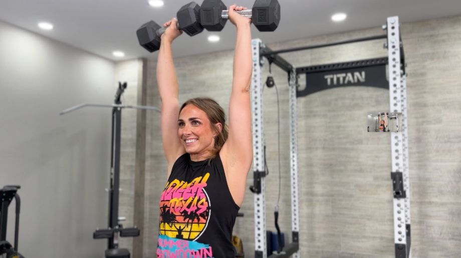 woman pressing dumbbells overhead